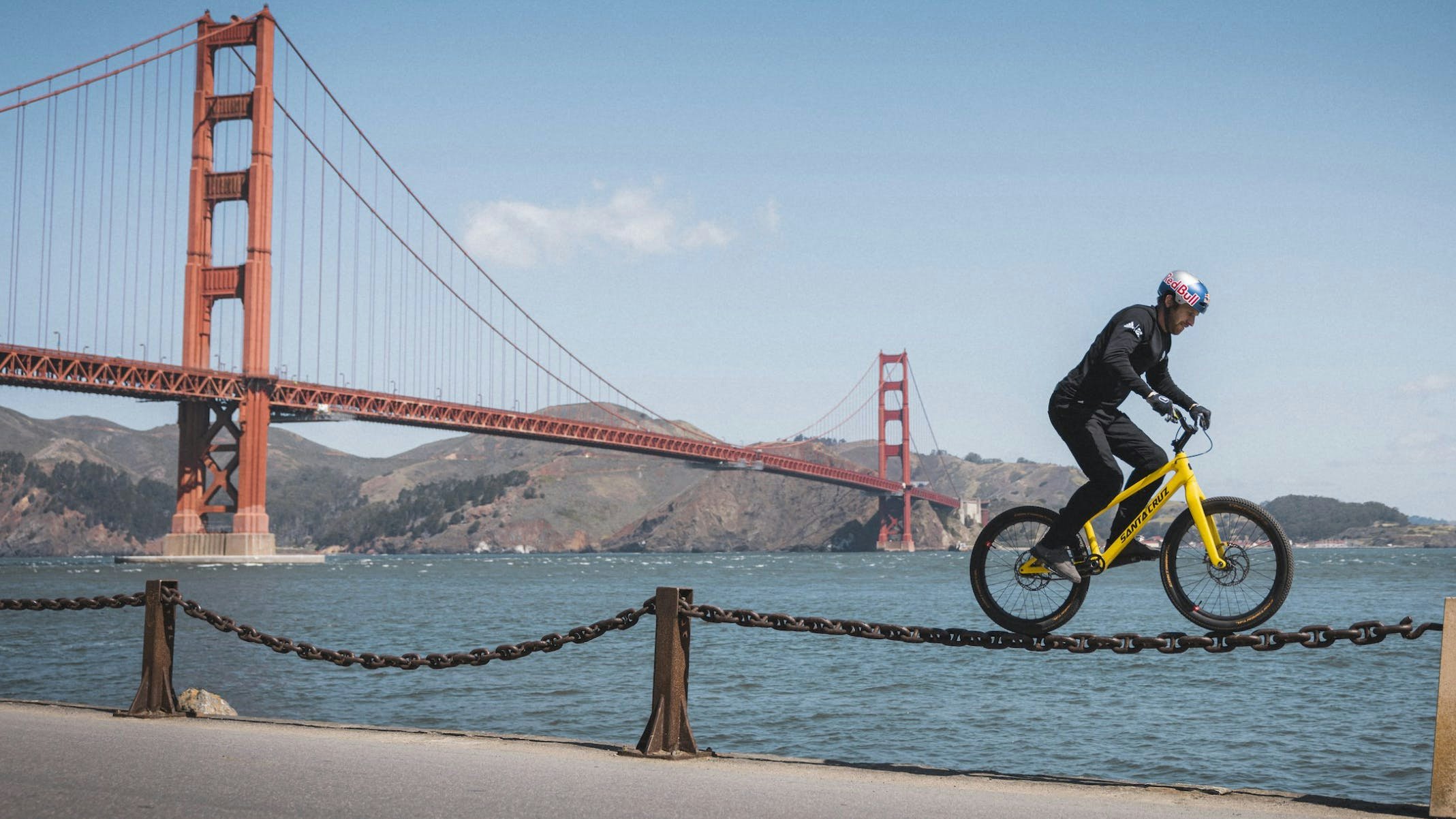 Danny Macaskill riding along a chain in front of the Golden Gate Brige at Fort Point in Postcard from San Francisco 