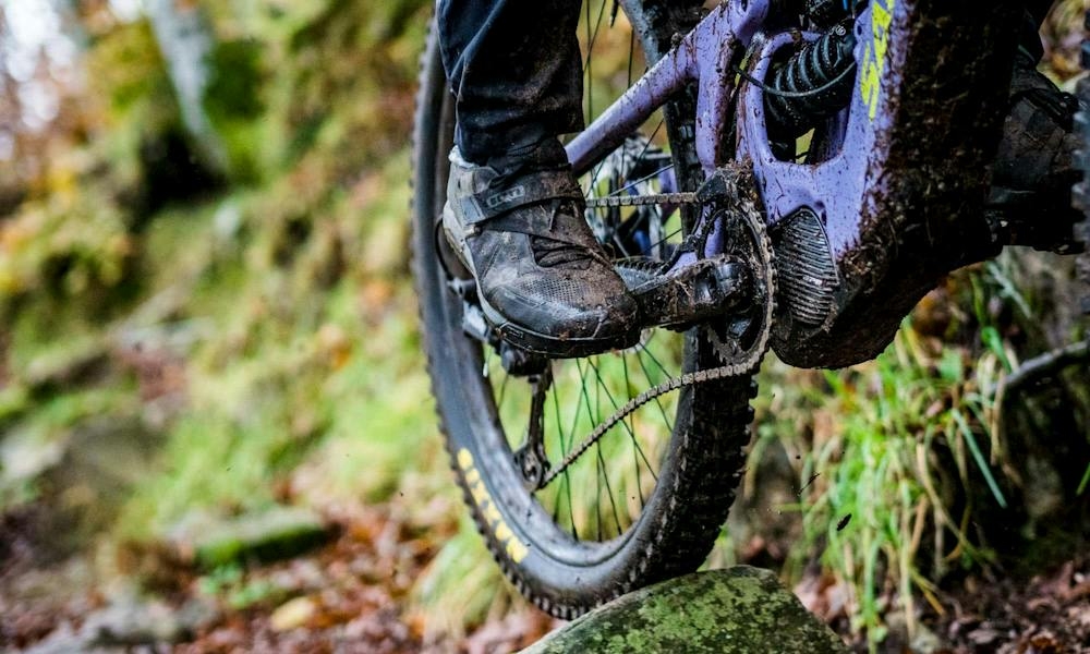 The 2021 Bullit being ridden down a muddy trail