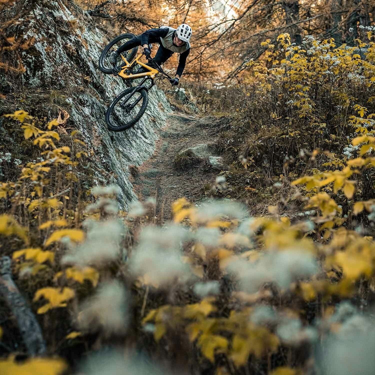 A mountain bike riding his Santa Cruz Bronson on a steep rocky wall ride