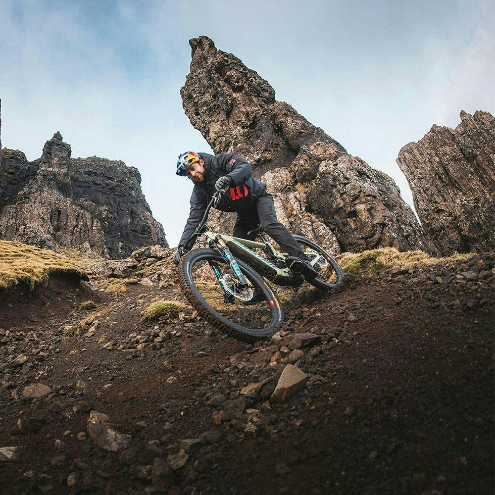 Danny MacAskill riding his Heckler downhill on a singletrack trail