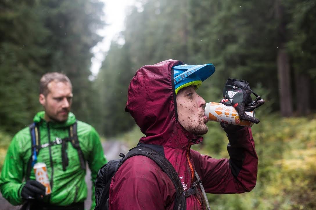 2 mountain bikers drinking beer
