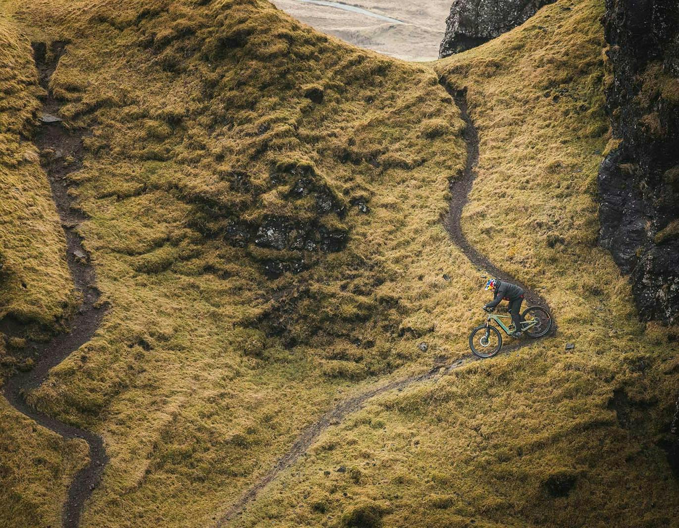 Danny MacAskill riding his Heckler eMTB downhill on a steep rocky trail