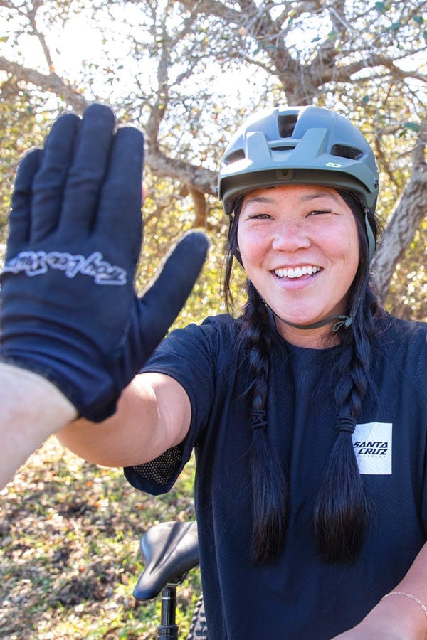 Santa Cruz Bicycles employee Sarah Bietsch high fiving a photographer