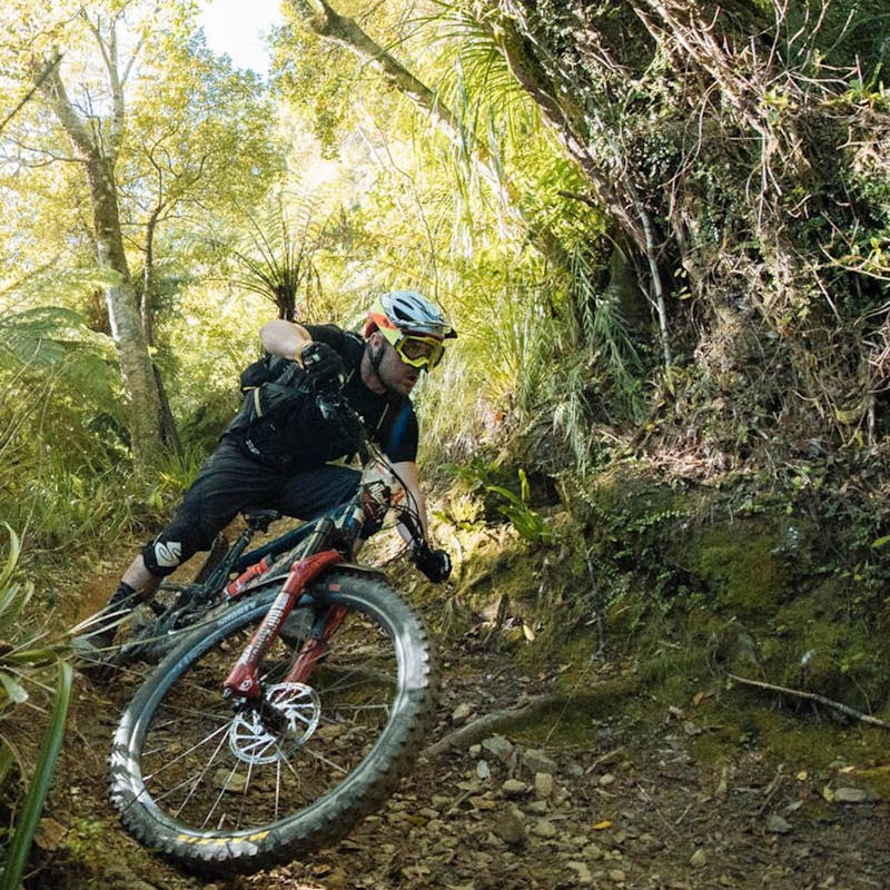 A mountain biker racing the New Zealand Enduro on a Santa Cruz Mountain Bike