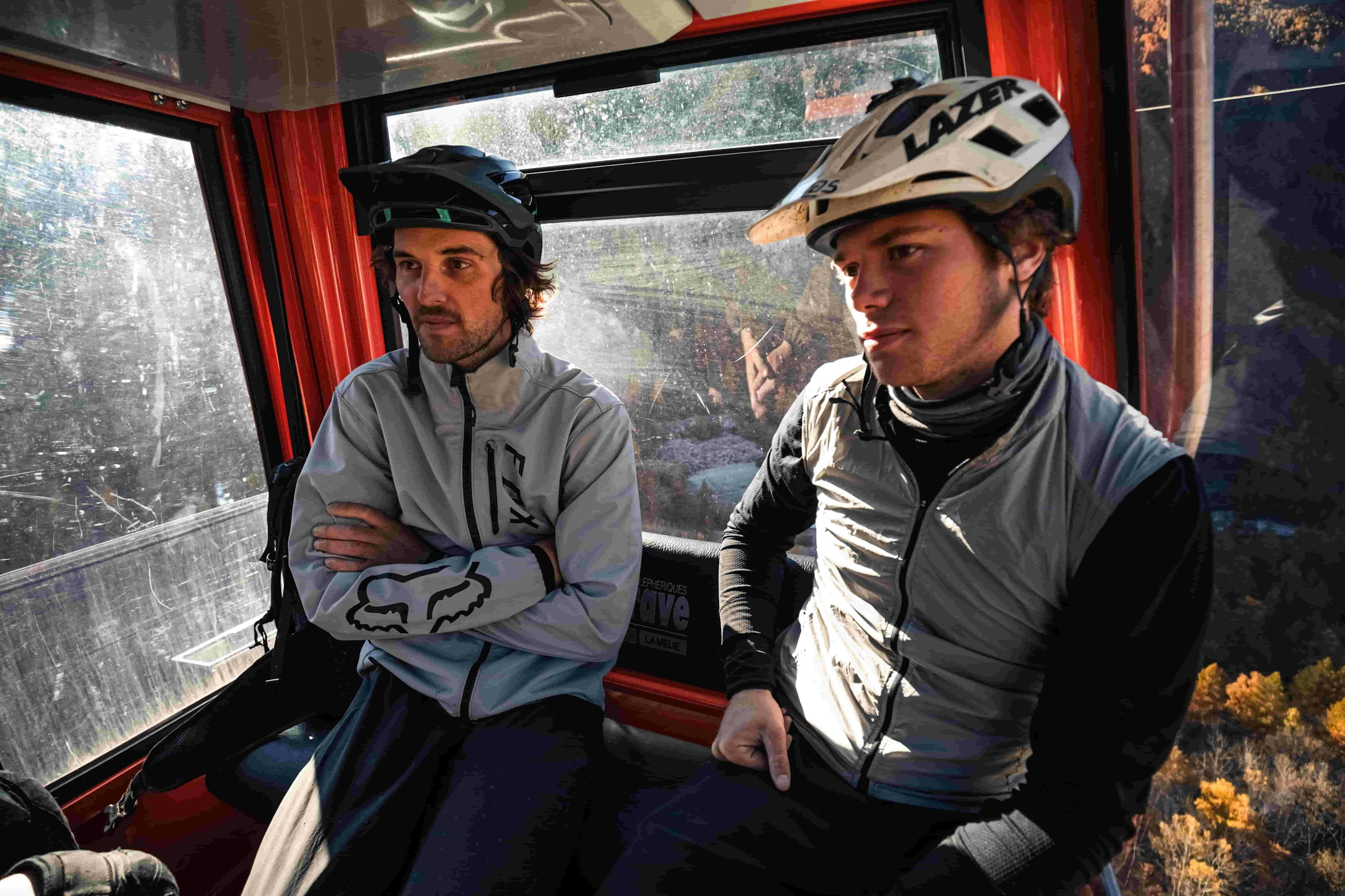 Loic D and another mountain biker riding in a gondola in La Grave