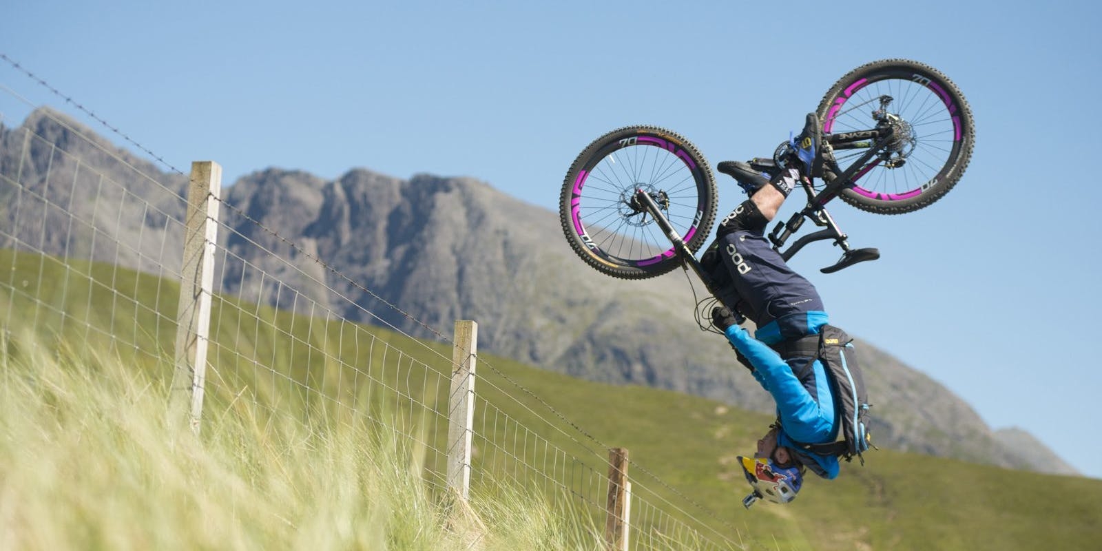 Danny MacAskill front flipping over a fence