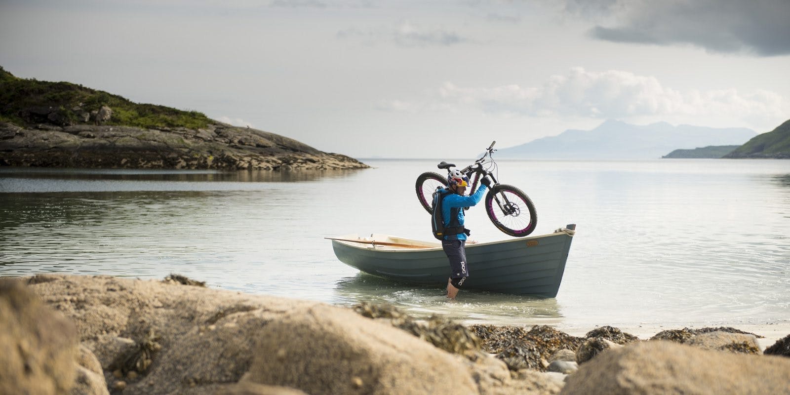 Danny MacAskill unloading his Nomad from a canoe