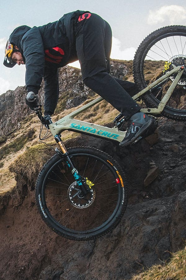 Danny MacAskill riding his Hecker eMTB downa steep trail