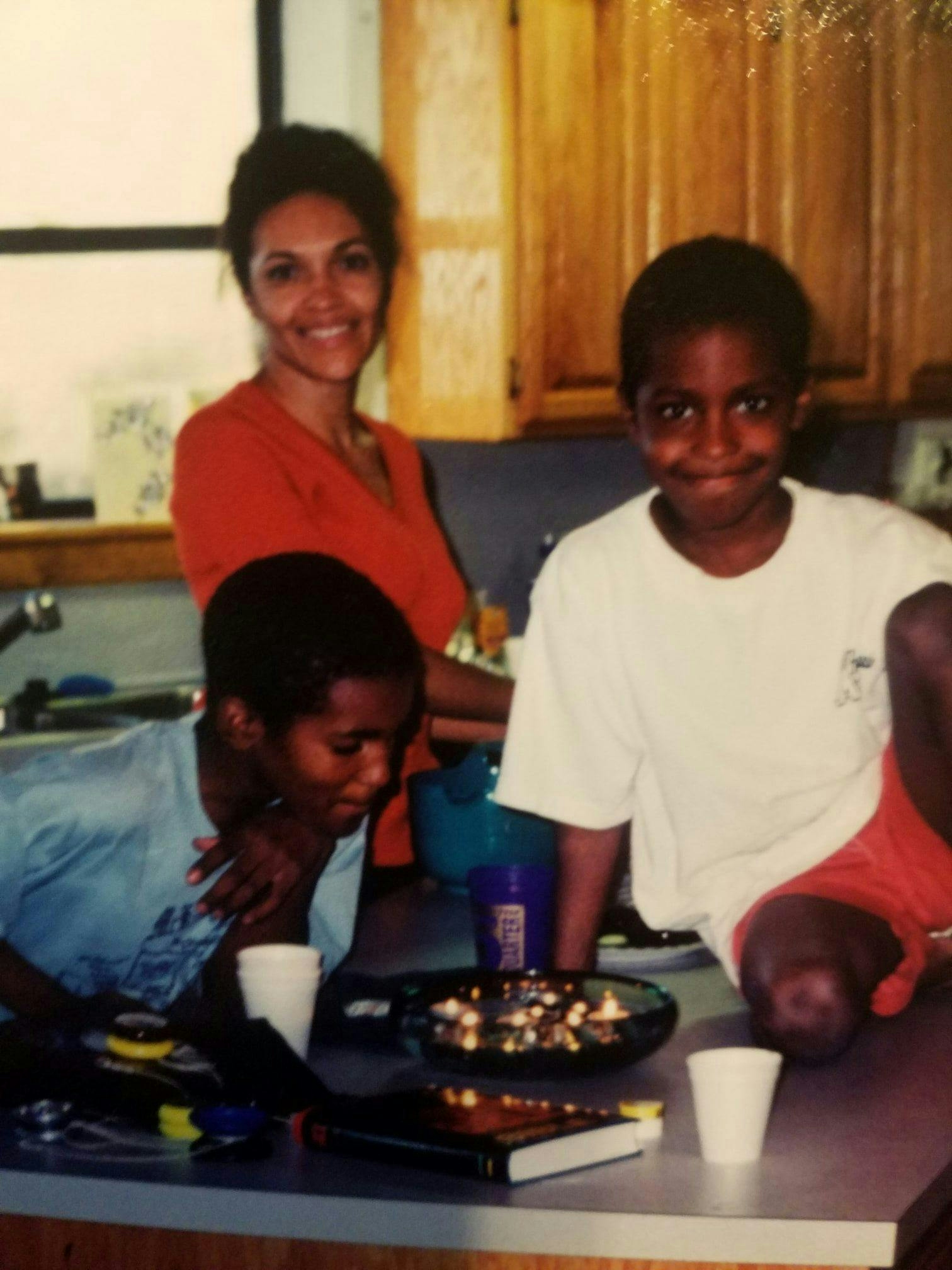 Joi Jackson and her two sons in their house