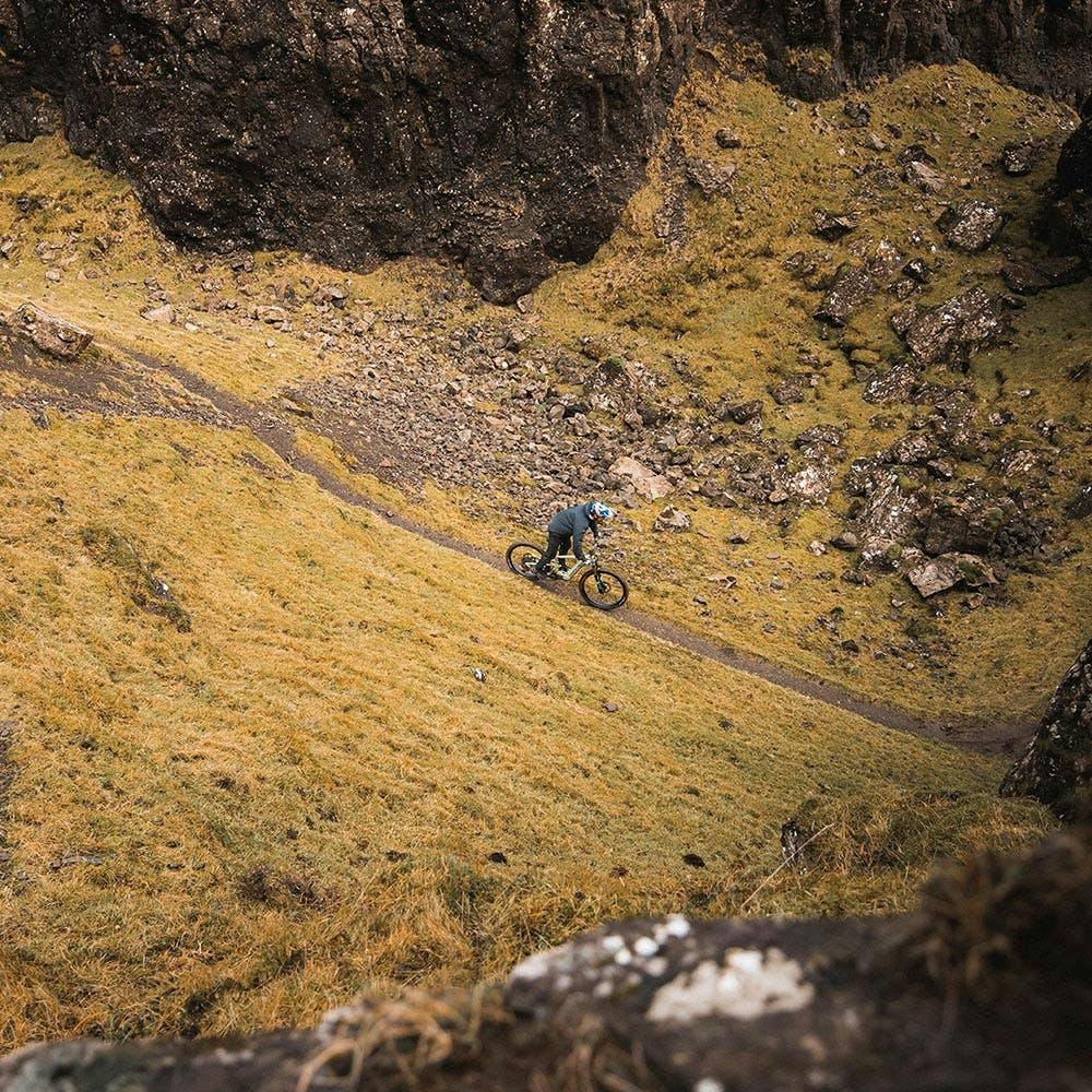 Danny MacAskill riding his Heckler on a singletrack trail