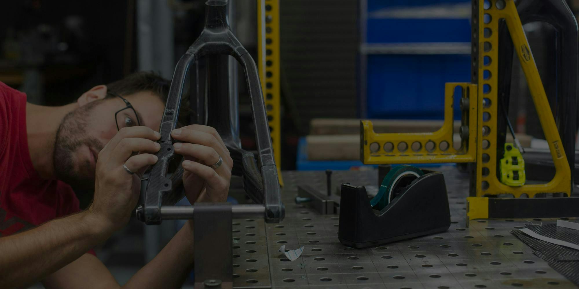 An engineer inspecting the rear triangle on a hardtail mountain bike frame