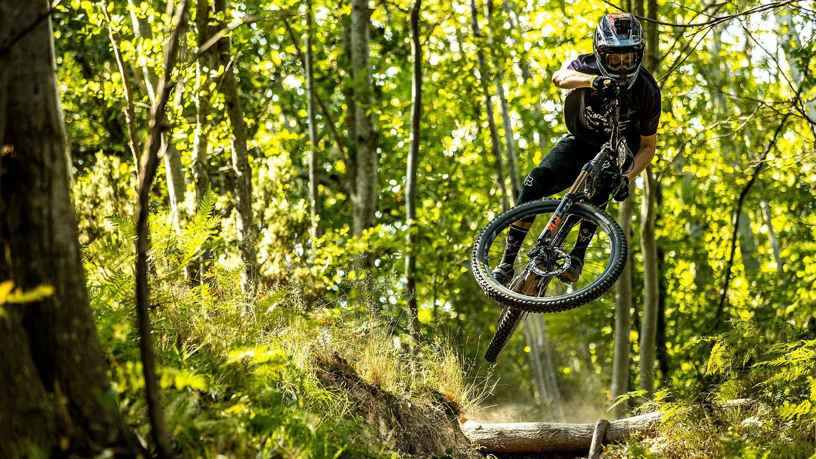 Mark Scott jumping his mountain bike in the woods