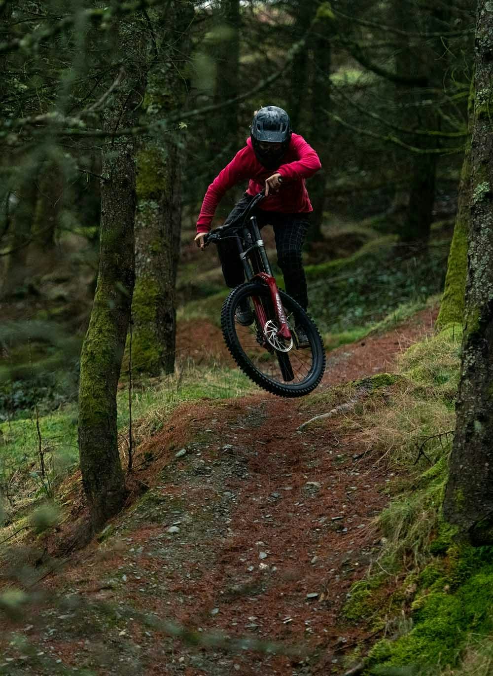 Veronique Sandler riding her downhill bike in the woods
