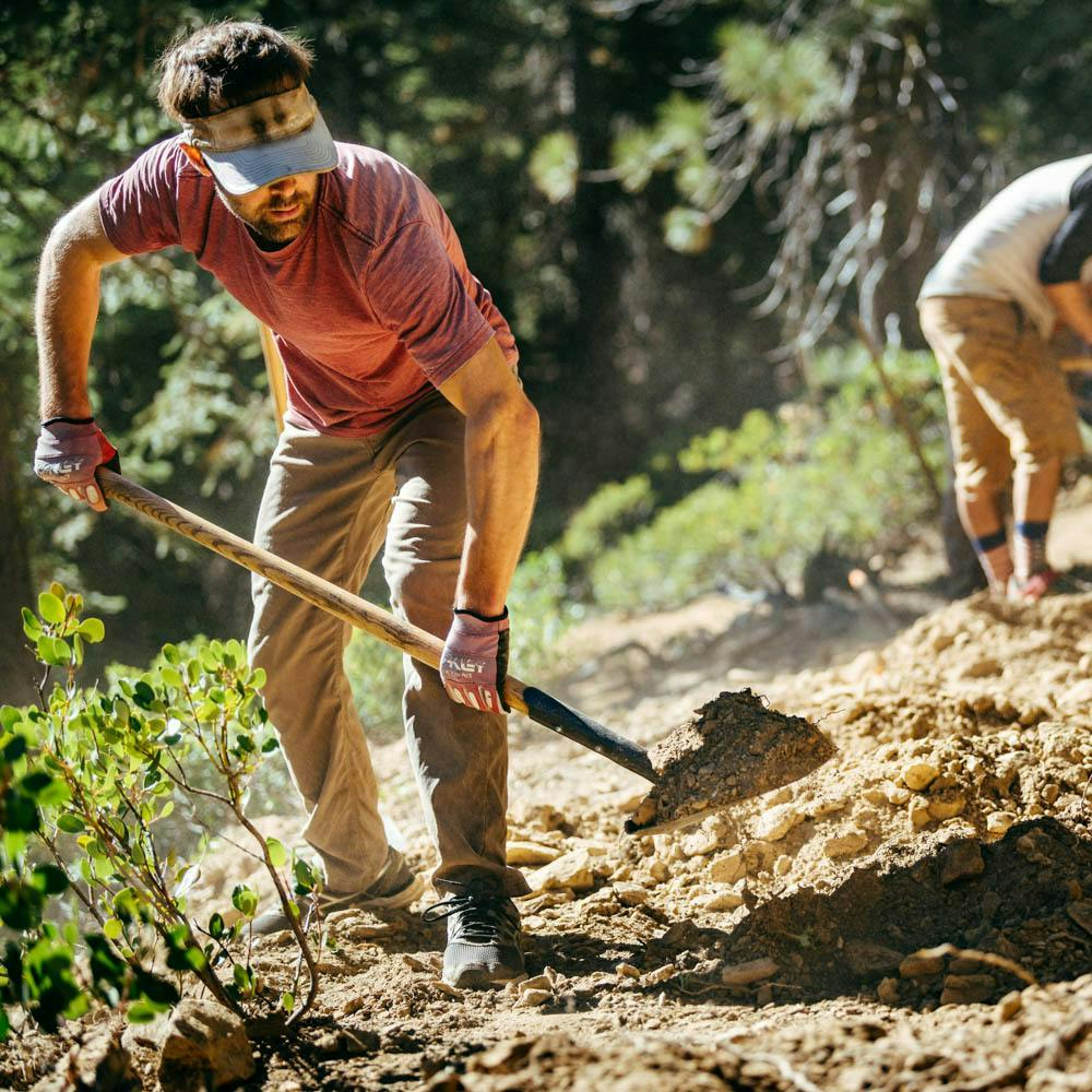 Sierra Buttes Trail Stewardship (SBTS) trail crew shoveling in the Sierra-Nevada Mountains
