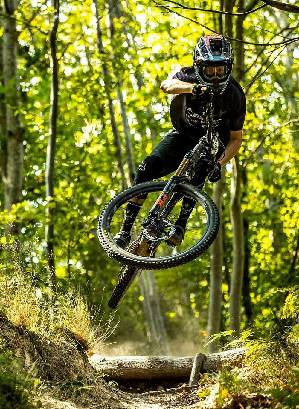 Mark Scott jumping his mountain bike in the woods