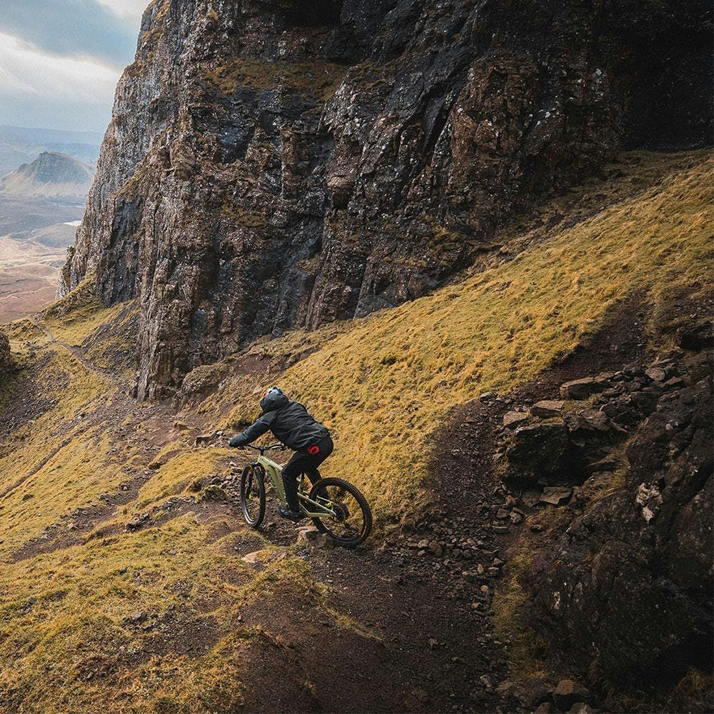 Danny MacAskill riding his Heckler downhill on a rocky singletrack trail