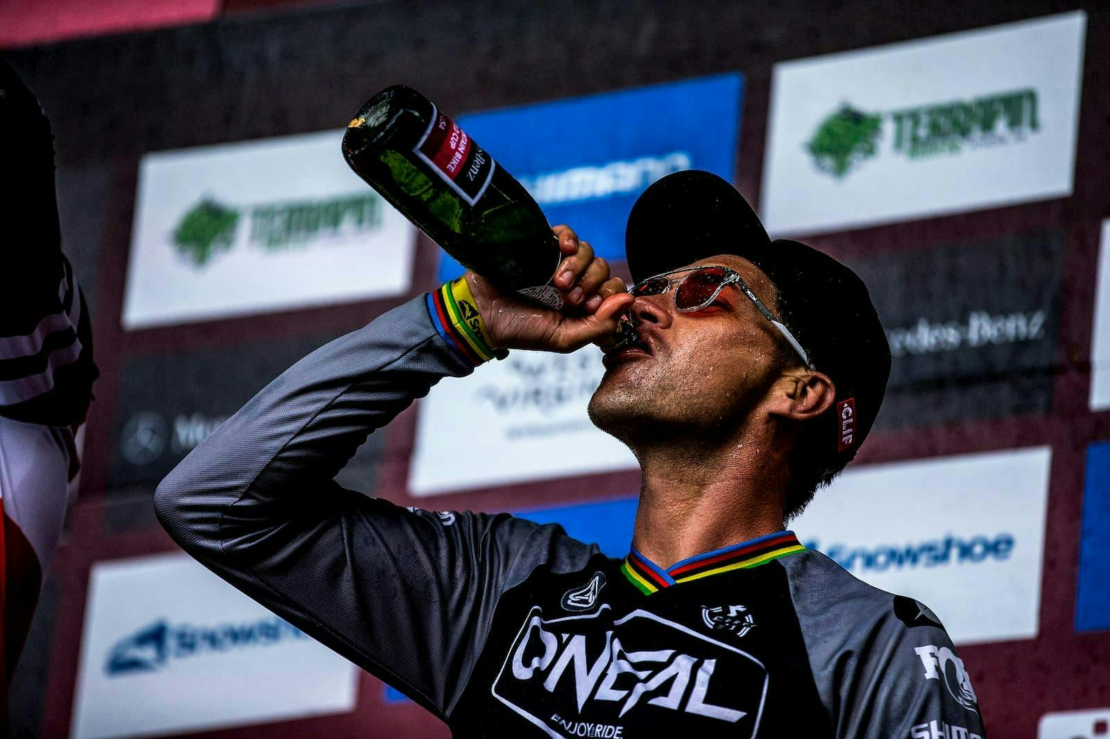 Greg Minnaar drinking on the podium