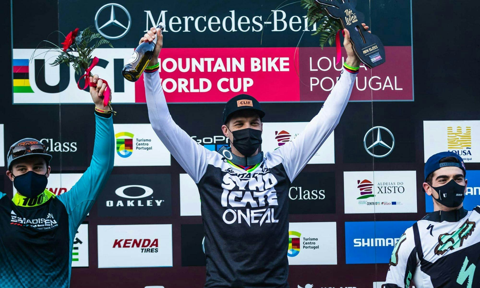 Greg Minnaar standing on the podium in first place