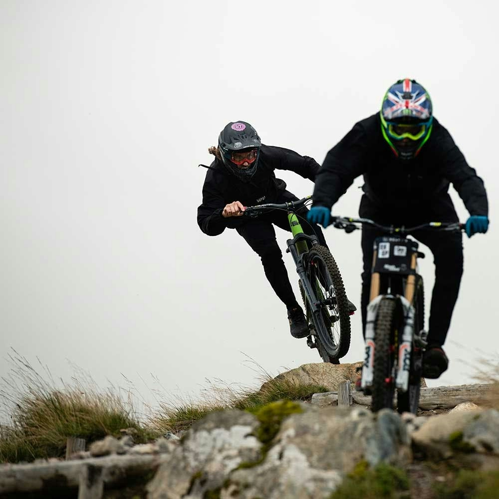 Two mountain bikers riding Nomads in fog