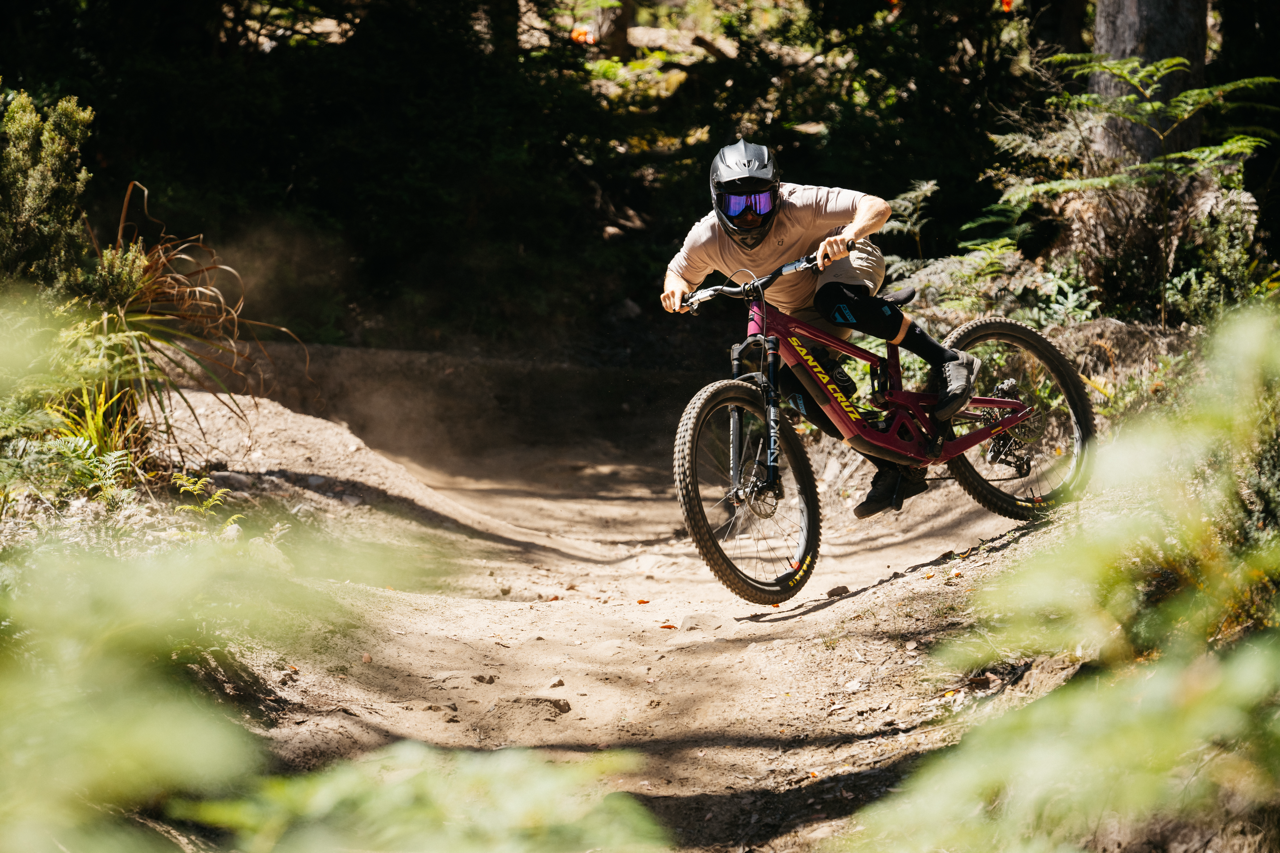Person riding a mountain bike on a dirt trail in a forest