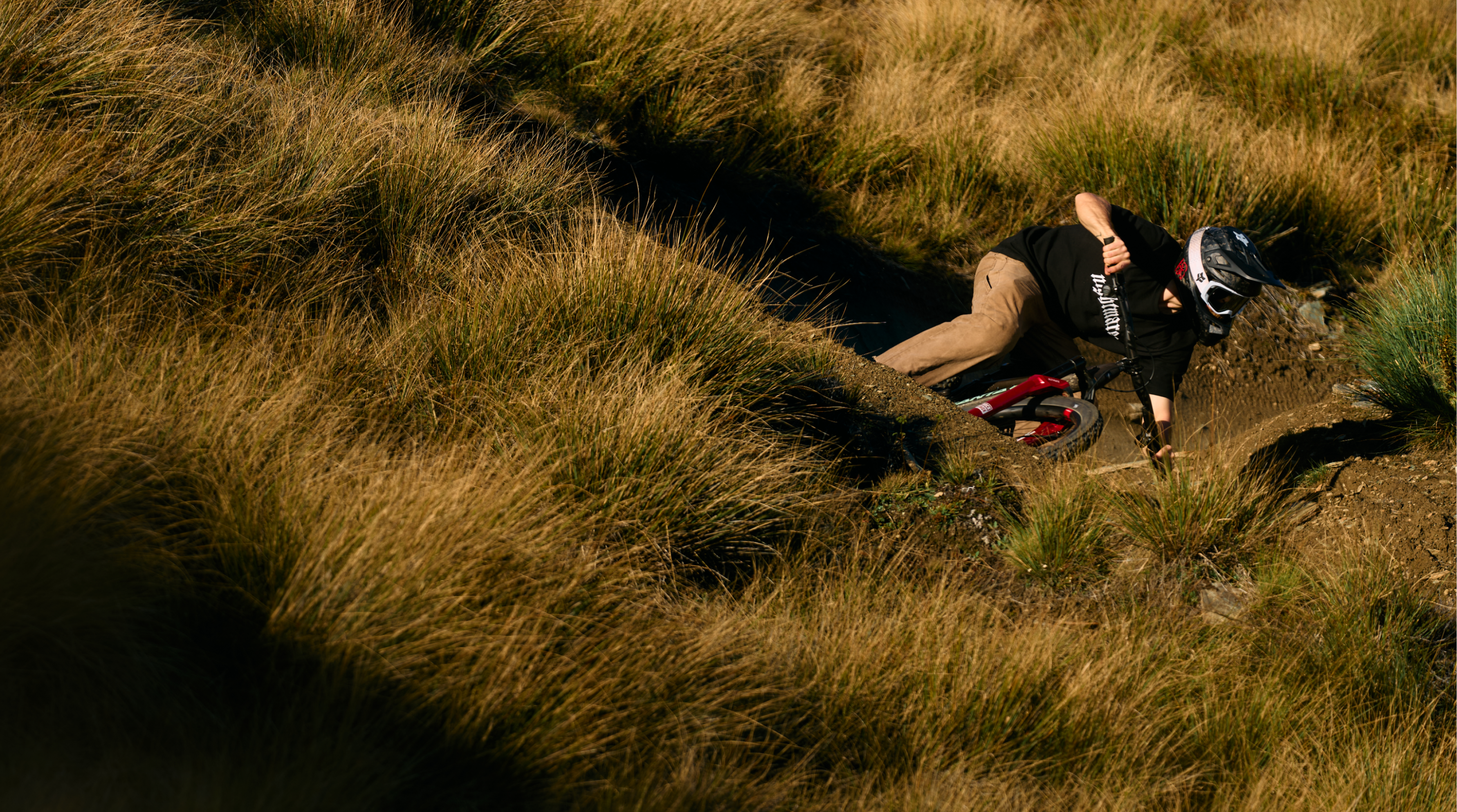 Person riding a mountain bikein a grassy field 
