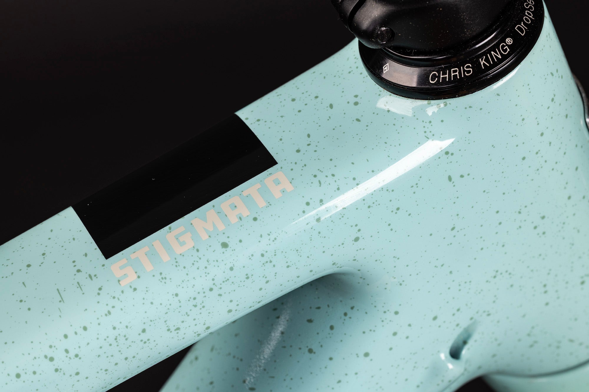 Close-up of a bicycle frame with 'Stigmata' branding and 'Chris King' component.