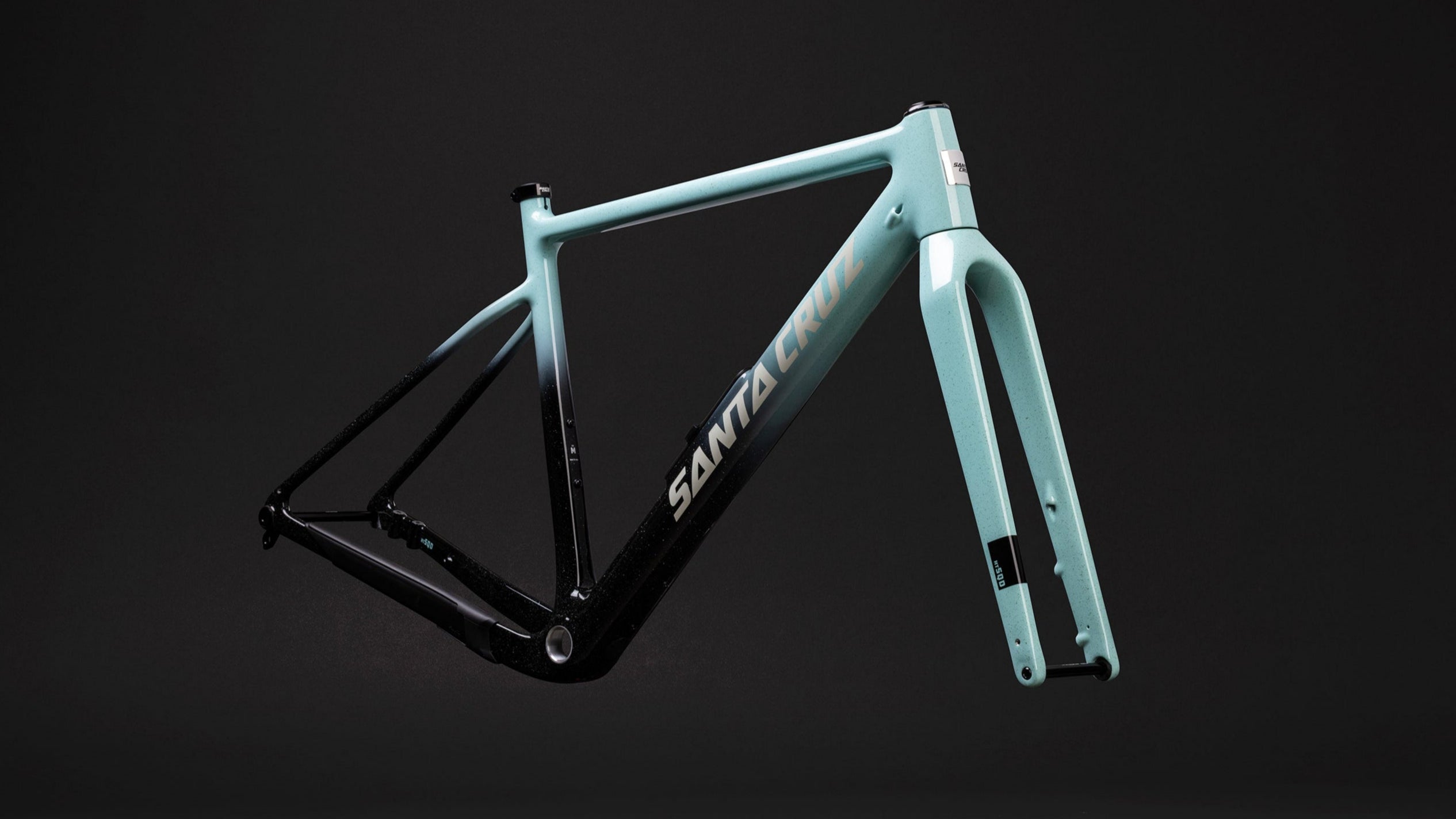 Bicycle frame with 'Santa Cruz' branding on a black background