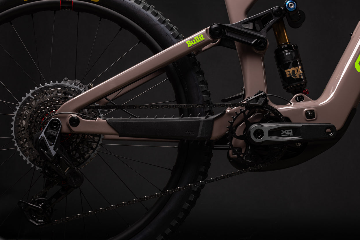 Close-up of a bicycle's chain mechanism with a dark background