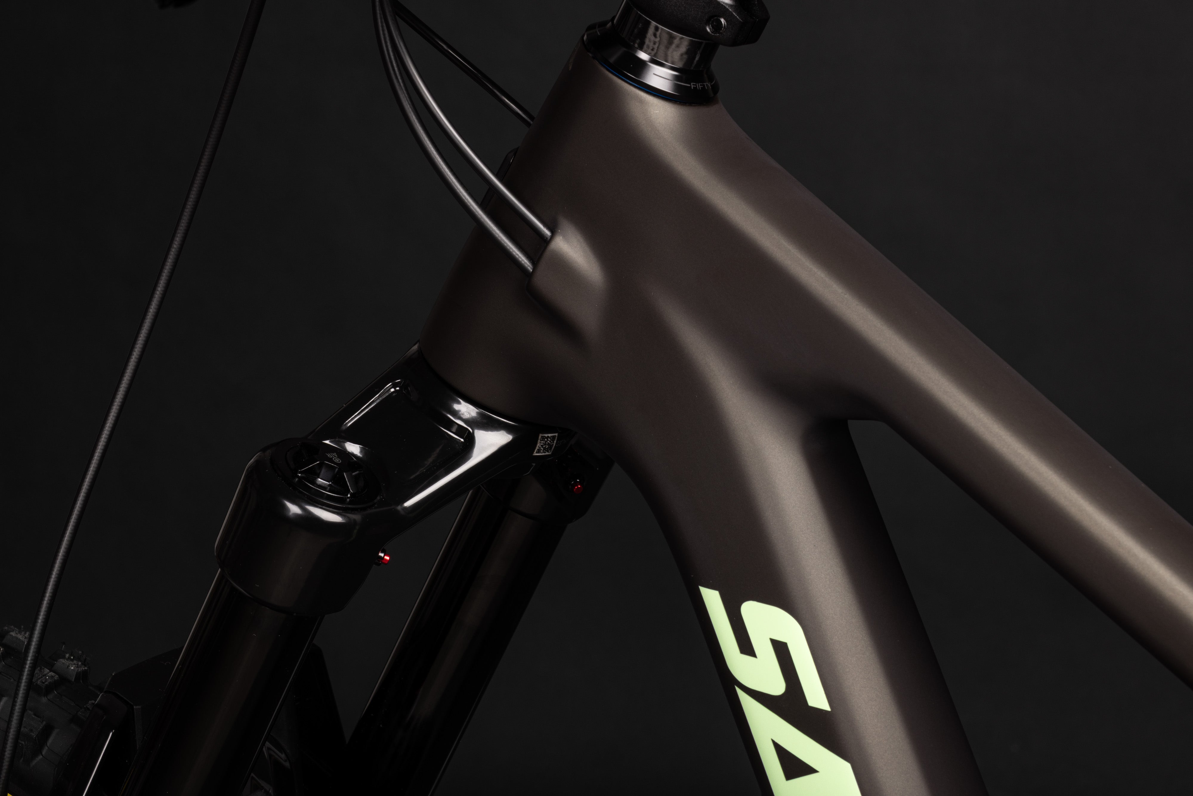 Close-up of a bicycle frame with 'Specialized' branding on a dark background
