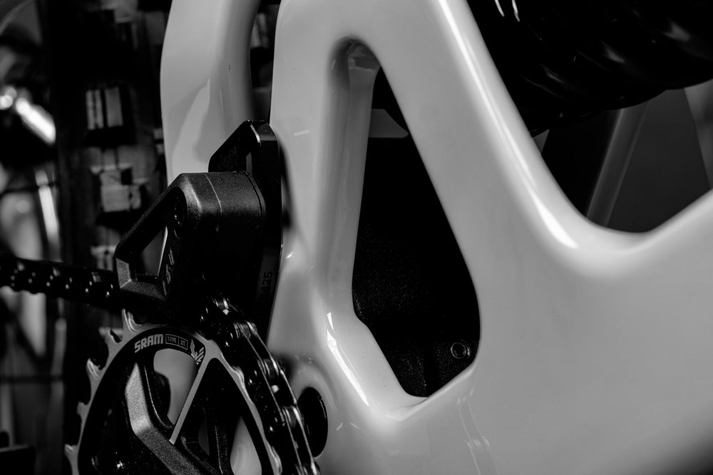 Close-up of a bicycle chain and gear system with a blurred background