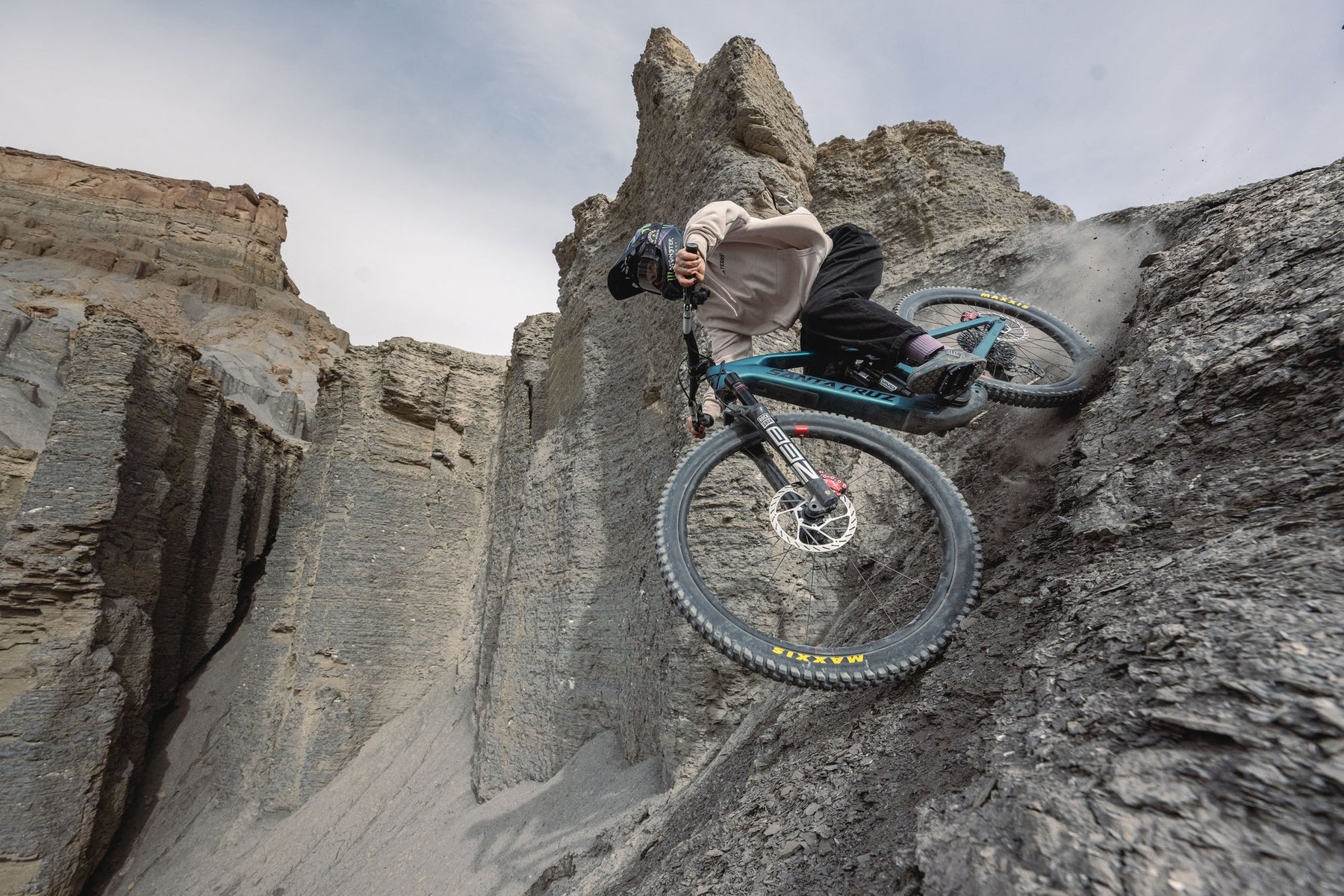 Person on a mountain bike performing a stunt in rocky terrain