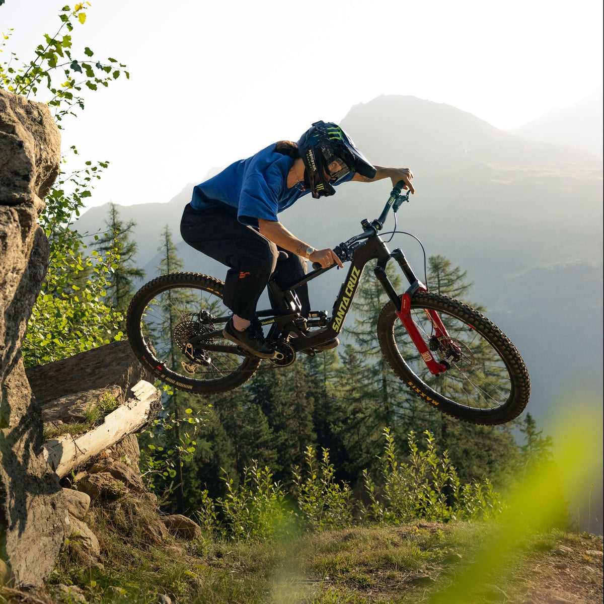 A mountain biker jumping on her full suspension mountain bike