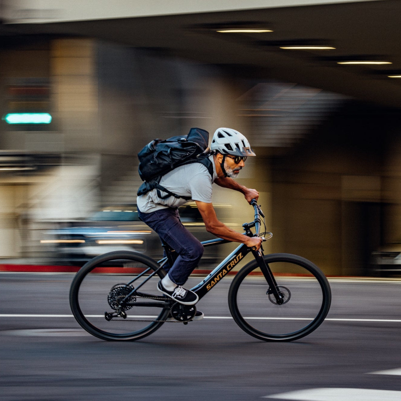 Person riding a bicycle in an urban setting with blurred background